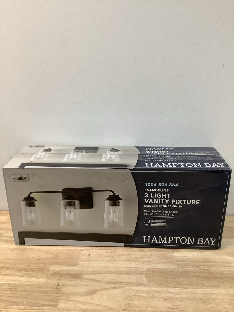 Hampton bay 1016HBMBZDI Evangeline 23 in. 3-Light Modern Bronze Farmhouse Bathroom Vanity Light with Clear Seeded Glass Shades